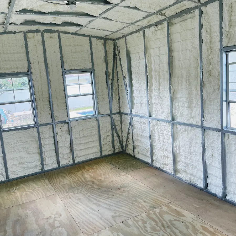 Closed-cell spray foam insulation applied to wall cavities in a residential project in Racine